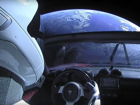 Tesla car floating in space with a space suit on board